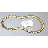 A curb pattern necklace, the heavy flattened necklace with concealed clasp, marked 585, length 42cm