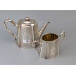 A Victorian silver part tea set, comprising cartouche shaped teapot and sucrier with flat chased dec