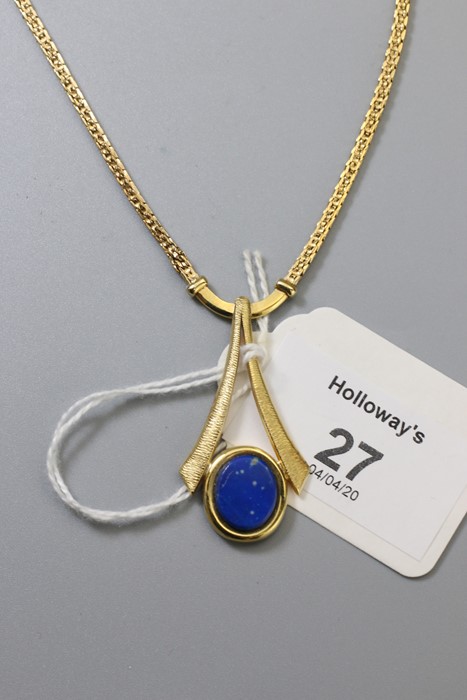 A lapiz lazuli set pendant, the oval stone in textured bi-furcated mount, to a fancy link chain, mar
