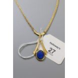 A lapiz lazuli set pendant, the oval stone in textured bi-furcated mount, to a fancy link chain, mar