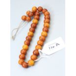 An amber bead necklace of circular chestnut coloured beads, 40cm, 37g Holloway's do not guarantee a