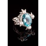 A French aquamarine, diamond and cultured pearl dress ring, the large oval aquamarine four claw moun