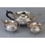 A 1930s silver three piece tea set, of pot bellied panelled form, including teapot, sucrier and milk