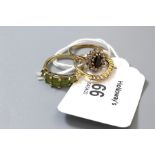 A five stone half hoop peridot ring, a cluster ring, and a clear stone ring stamped '585', 5.6g