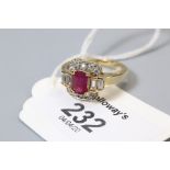 A ruby and diamond cluster ring, the rectangular step cut ruby with two baguette diamonds to each sh