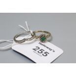 An 18ct white gold and diamond wishbone shaped ring, together with an emerald and diamond cluster ri