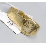 Bulova, a lady's 18ct white gold wristwatch, the rounded oblong brushed gilt dial with baton numeral