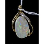 A single stone opal and diamond pendant, the ovoid opal in diamond set scrolling mount, marked '750'