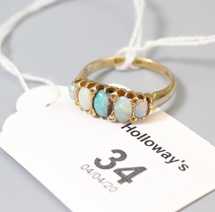A five stone half hoop opal ring, with diamond detail to 18ct gold pierced claw mount, Ring size Q,