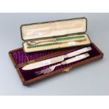 A cased Victorian and mother of pearl bread and cake serving set, engraved foliate blades and tines