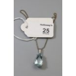 A single stone aquamarine pendant, the pear shaped stone in four claw mount, to a flattened curb pat