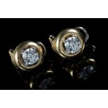A pair of single stone diamond earrings, the brilliant cut diamonds in four claw mounts, above a cir