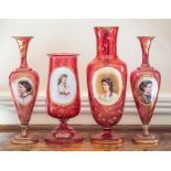 A group of four Bohemian ruby and overlay glass portrait vases,