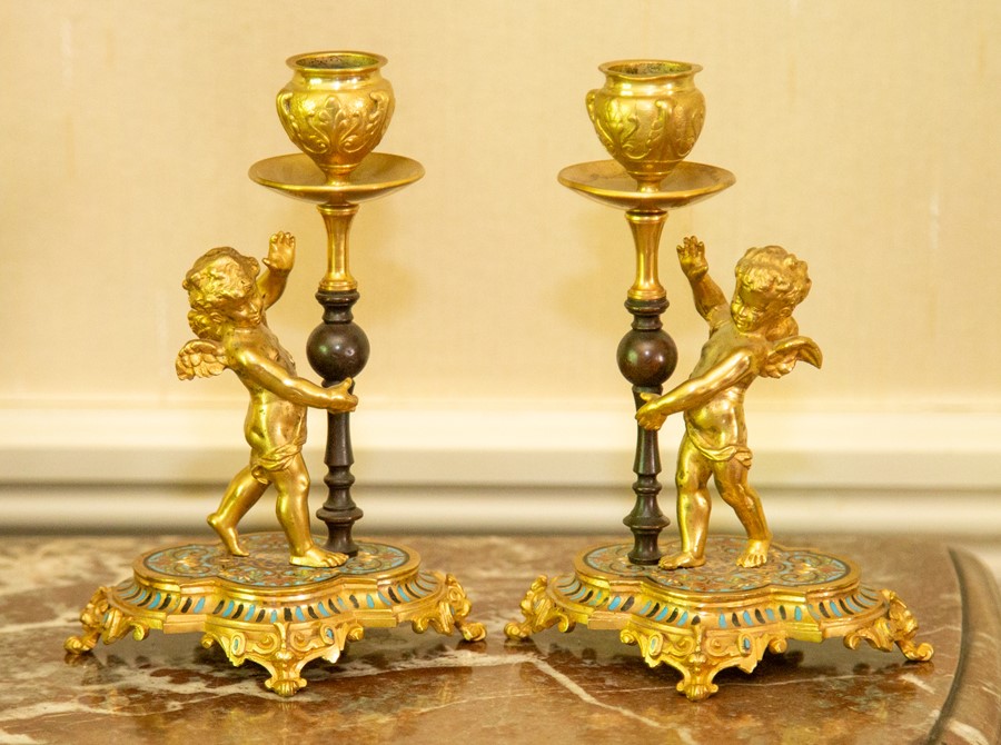 A pair of French ormolu and champleve enamel candle holders,