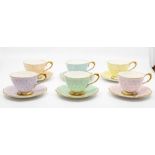 A harlequin set of six Paragon porcelain teacups and saucers, mid-20th Century, decorated with