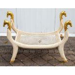 A reproduction Empire style cane seated painted and parcel gilt stool, 20th Century, the scroll arms