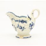 A Worcester Dolphin Ewer, circa 1770, of shell-moulded form and painted in blue with fruits and