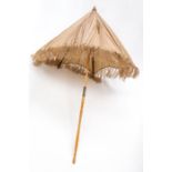 A Victorian silk parasol, the turned boxwood handle with centre fold, the champagne silk with tassel