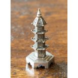 A Chinese silver pepper pot by Wang Hing, circa 1890, modelled as a four-tiered pagoda, 7.5cm high.