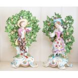 A pair of Continental porcelain bocage figures,
