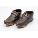 A pair of brown ridged leather clog design boys shoes, high fronts with a metal bar design and toe