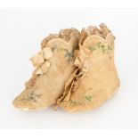 A pair of deep cream children's bootees, with scalloped shape, edged in lace and silk ribbon