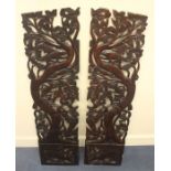 A pair of Baliniese carved hardwood wall panels, modern, of rectangular outline and carved with