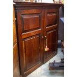 An 18th Century Welsh oak cupboard, the moulded ogee cornice above twin panelled doors, the base