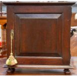 A Georgian oak spice cupboard, the ogee cornice above a single panelled door enclosing a fitted