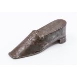 A 19th Century pewter snuff box, modelled as a shoe with punched stitching detail, 12.5cm long.