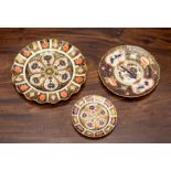 A group of three Royal Crown Derby Imari plates, of circular shape and decorated with various