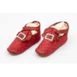 A pair of quilted crimson shoes made for a child from a wealthy family, the front has a fluted