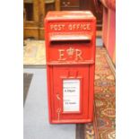 A reproduction 'ER' cast iron post box, in red livery with gilt detail, with two brass keys, 56cm