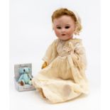 A 19th Century porcelain doll, AF, clothed, together with a miniature modern teddy bear (2)