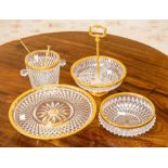 A suite of pressed glass and yellow metal tablewares including serving dishes and an ice pail.