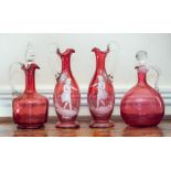 A pair of 'Mary Gregor type cranberry glass ewers,
