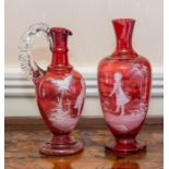 A Mary Gregory type cranberry glass amphora vase, 24cm high, and a ewer, 24cm high (2)