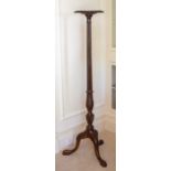 A Victorian mahogany torchere, circa 1870,the circular top with gadrooned edge above a reeded column