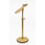 A Harris & Sheldon brass shoe display stand.