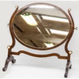 An Edwardian mahogany and ivory inlaid dressing table mirror, the oval plate within a plain frame,