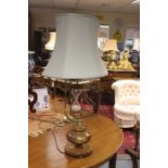 A reproduction mahogany table lamp with integral hour glass, modern, of turned onion form and