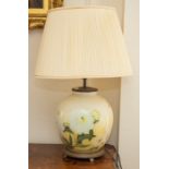 A modern table lamp, of globe form and reverse printed on glass with botanical studies.