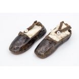 A pair of Tudders shoes with tiny black bow details and ankle straps, inscribed on the sole 1860