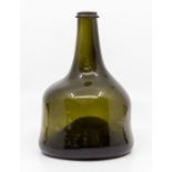 An 18th Century wine bottle, of squat mallet shape with deep kick, short neck and string rim, 18cm