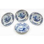 Three Chinese blue and white dishes, 18th Century, painted with peony blooms in a fenced garden,