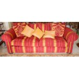 A modern three-seater Chesterfield sofa, upholstered in raspberry and champagne striped chenille