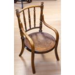 An Edwardian bentwood nursery open arm chair, stamped Humphrey, Rotherham, the back with three
