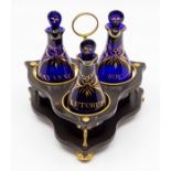 A Georgian Bristol blue glass three-bottle cruet, circa 1800, each bottle with a lozenge stopper and