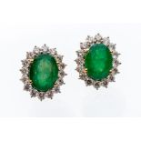 A pair of emerald and diamond 18ct yellow gold cluster stud earring, the oval cut emeralds