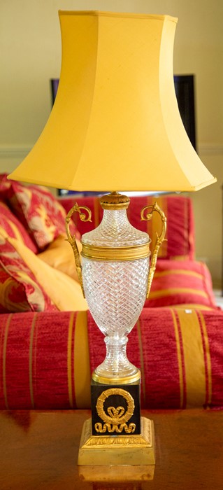 A pair of French cut glass and parcel gilt table lamps,